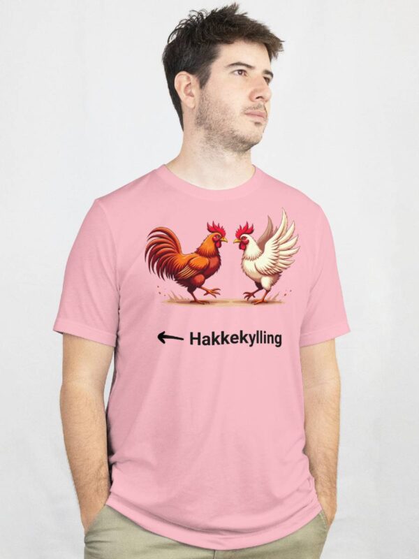 a man wearing a pink shirt with a picture of a rooster and a chicken